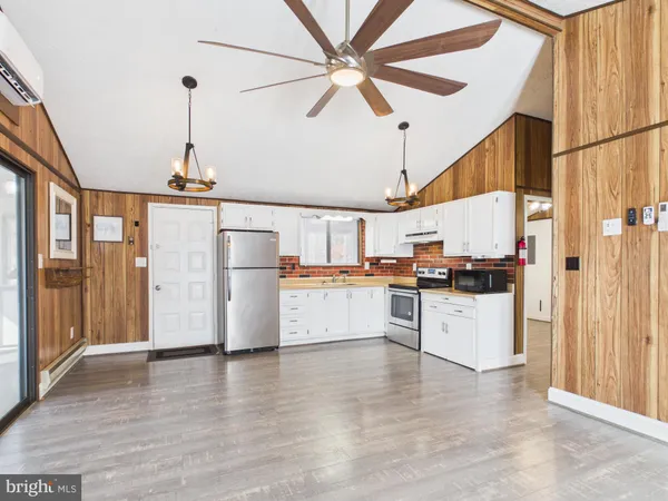 a kitchen with stainless steel appliances white cabinets and a refrigerator