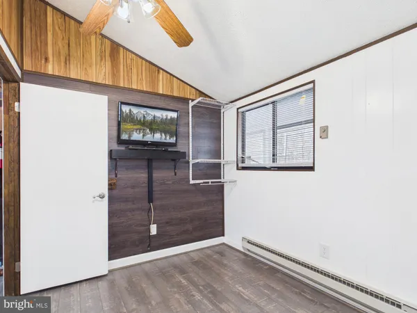 a view of kitchen with stainless steel appliances granite countertop cabinets and a window