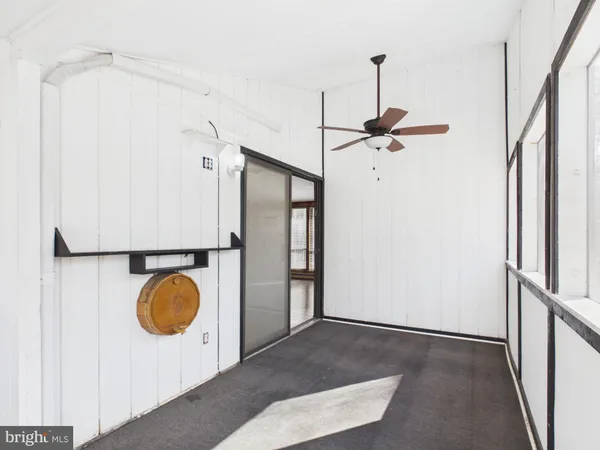 a view of a hallway with wooden floor and stairs