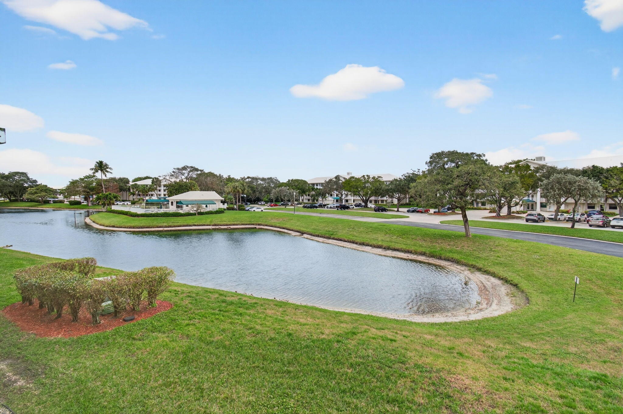 6049 Balboa Circle, Unit 205 Boca Raton, FL 33433 - Photo 24 of 27 a view of a lake with houses in back