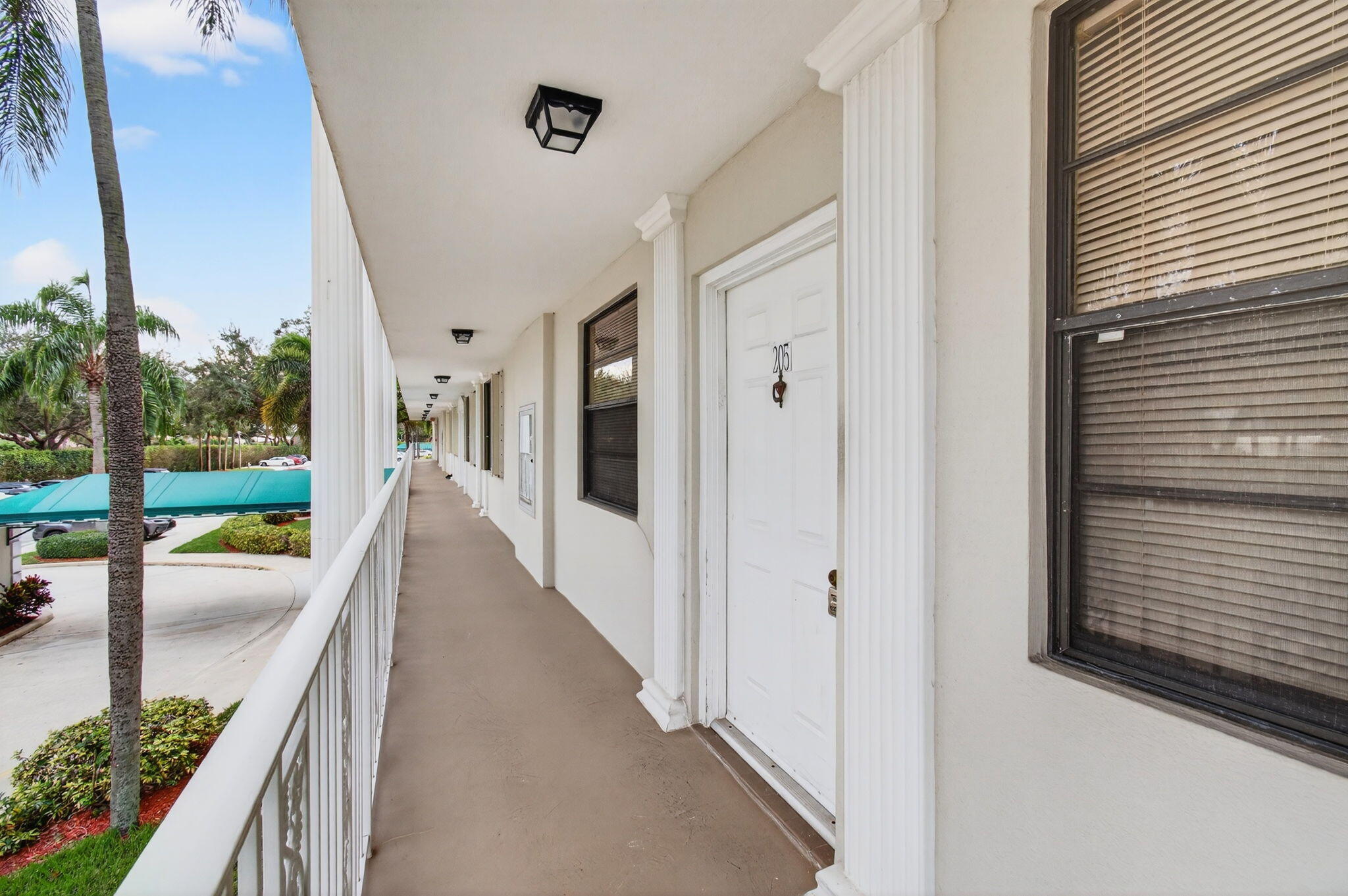 6049 Balboa Circle, Unit 205 Boca Raton, FL 33433 - Photo 3 of 27 a view of a hallway with wooden floor and outdoor space