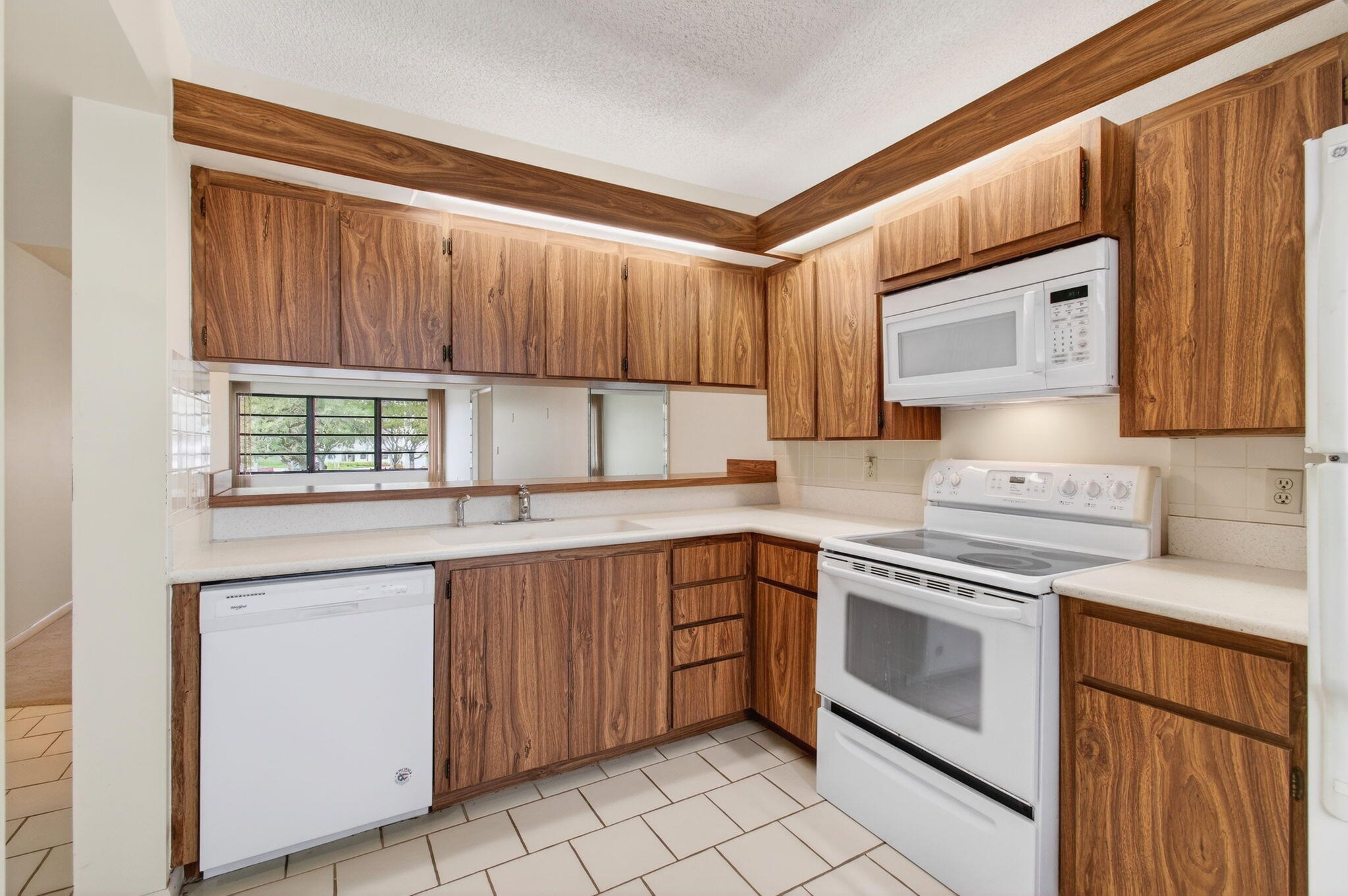 6049 Balboa Circle, Unit 205 Boca Raton, FL 33433 - Photo 8 of 27 a kitchen with a stove sink and cabinets