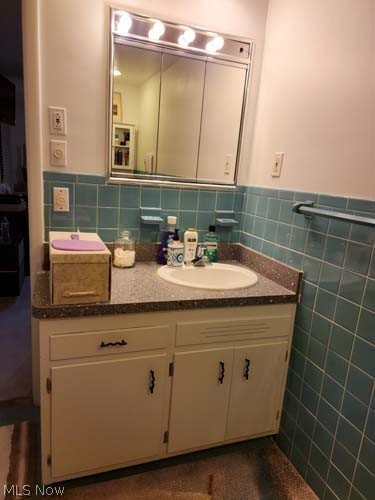 2443 Elmdale Road Cleveland, OH 44118 - Photo 21 of 24 Bathroom with backsplash, oversized vanity, and tile walls