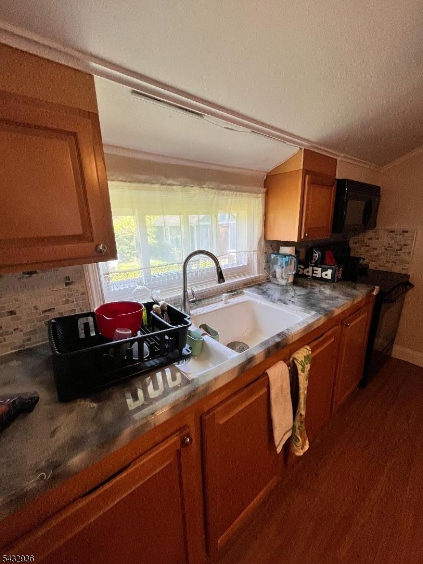 9 New Row Road, Unit A Hibernia, NJ 07842 - Photo 9 of 18 a kitchen with stainless steel appliances a sink a stove and a wooden cabinets