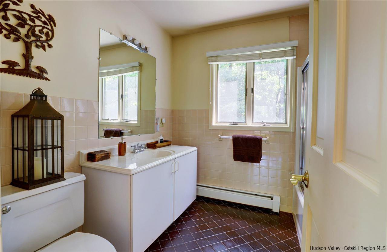 41 Mountain Road Mount Tremper, NY 12457 - Photo 19 of 33 a bathroom with sink a window and mirror