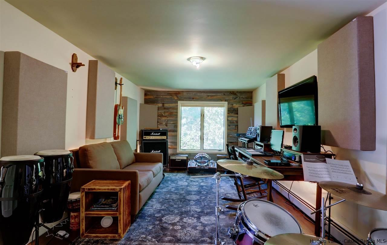 41 Mountain Road Mount Tremper, NY 12457 - Photo 24 of 33 a living room with furniture and a flat screen tv
