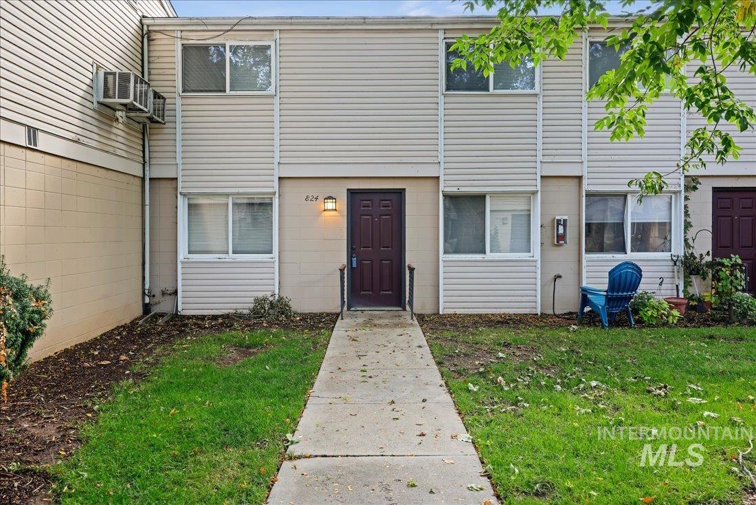 View of exterior entry featuring a yard