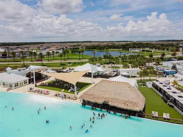 an aerial view of a house with a garden and lake view