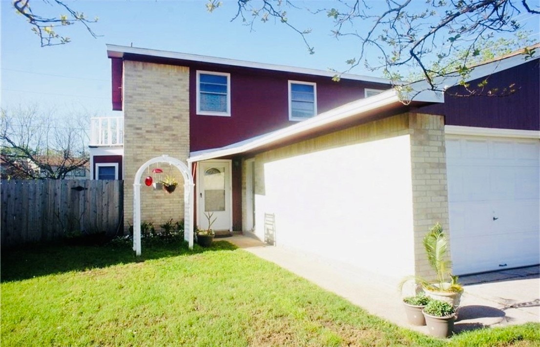 1409 Hawk Tree Drive College Station, TX 77845 - Photo 2 of 12 a front view of a house with garden