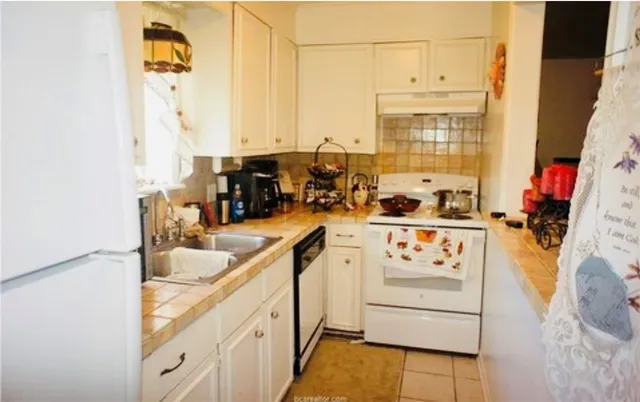 a kitchen with stainless steel appliances granite countertop a sink and cabinets