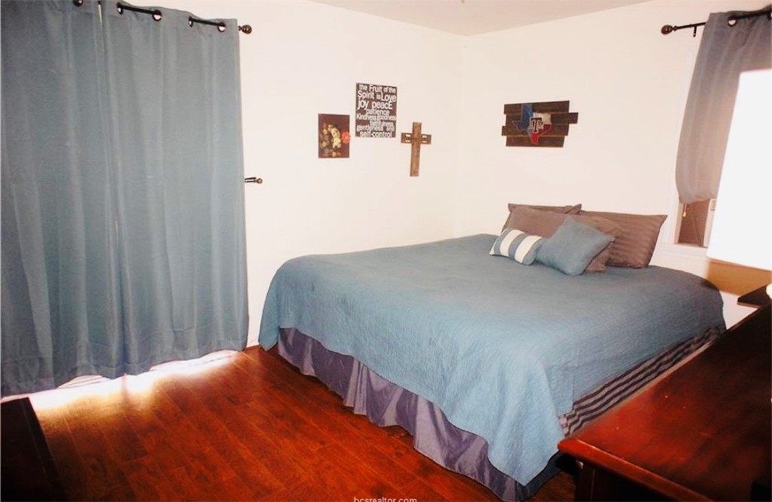 1409 Hawk Tree Drive College Station, TX 77845 - Photo 10 of 12 a bedroom with a bed and painting on the wall