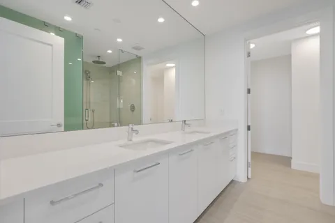 a bathroom with a double vanity sink mirror and double