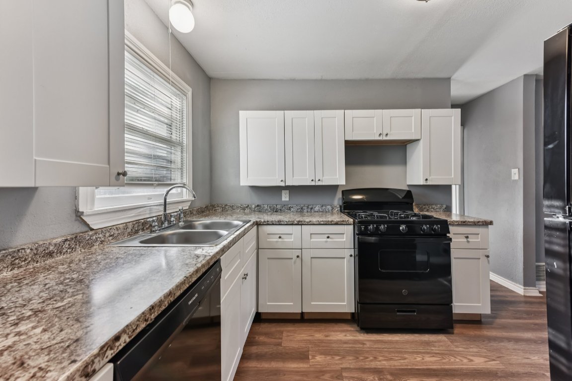 1102 Jackson Street Killeen, TX 76541 - Photo 2 of 16 a kitchen with a sink stove top oven and cabinets