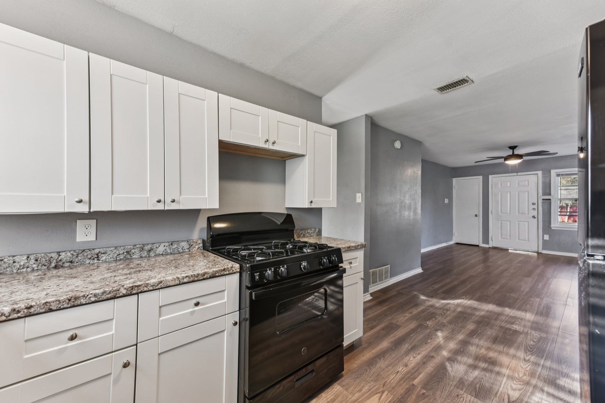 1102 Jackson Street Killeen, TX 76541 - Photo 6 of 16 a kitchen with granite countertop white cabinets and stainless steel appliances