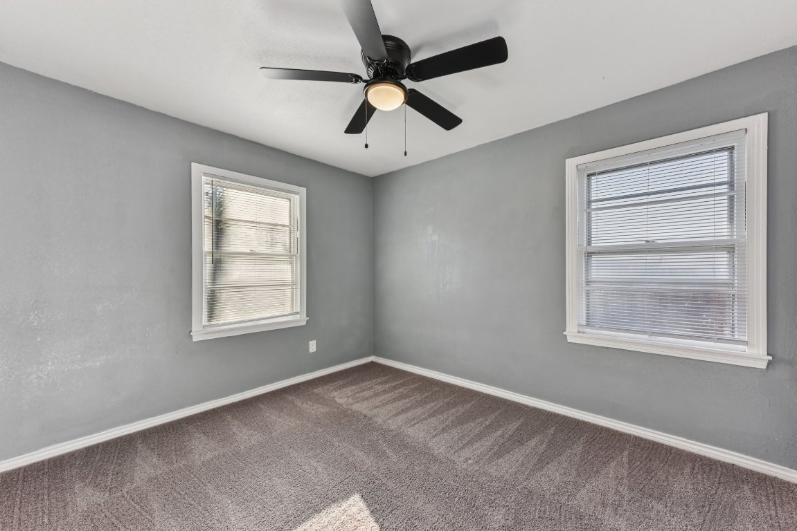 1102 Jackson Street Killeen, TX 76541 - Photo 7 of 16 an empty room with a window and a fan