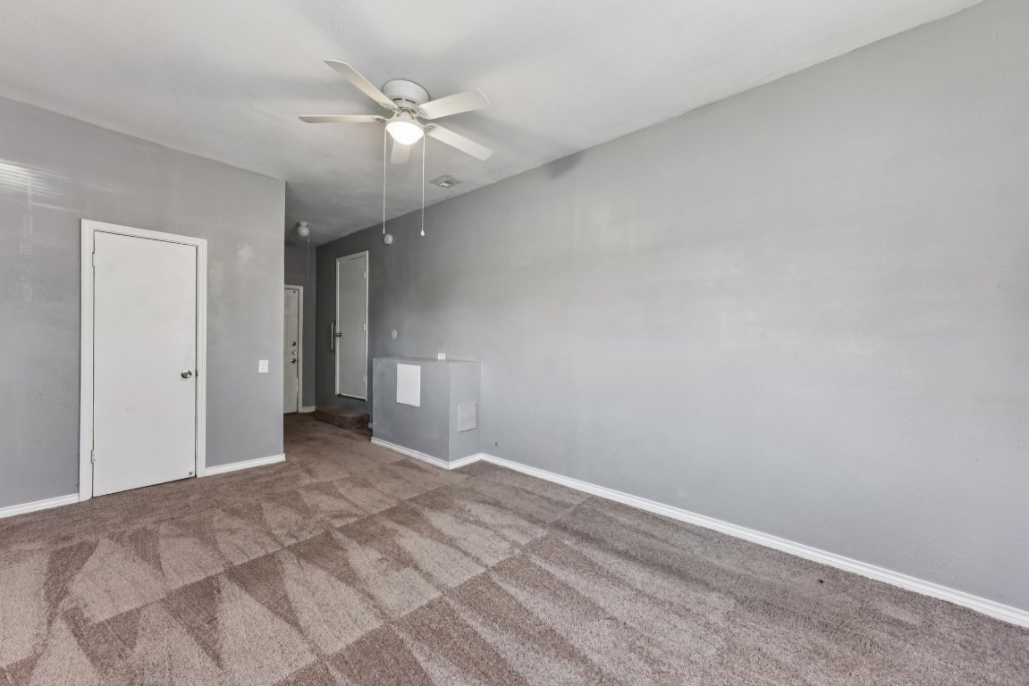 1102 Jackson Street Killeen, TX 76541 - Photo 8 of 16 a view of an empty room with a ceiling fan
