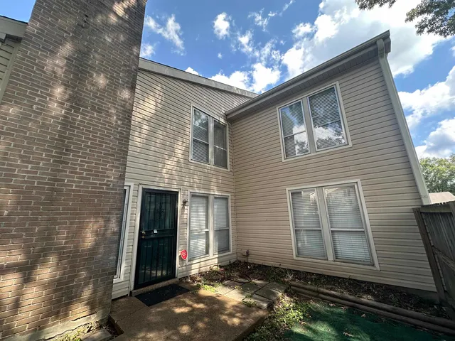a view of a house with brick walls