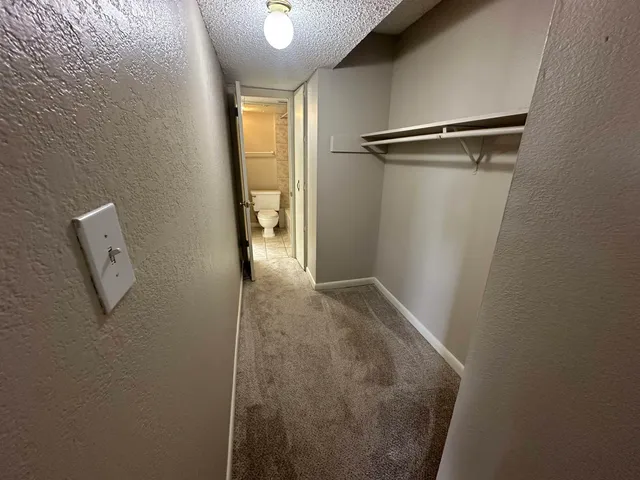 a white toilet sitting next to a bath tub
