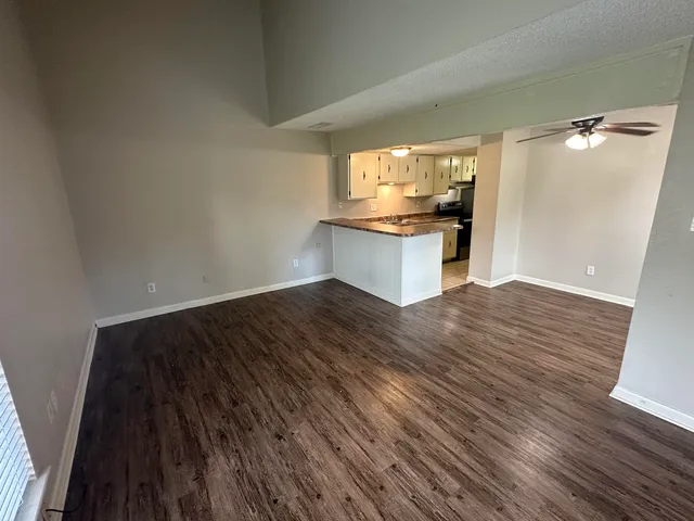 a view of a kitchen cabinets and wooden floor