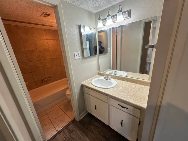 a white toilet sitting next to a bath tub