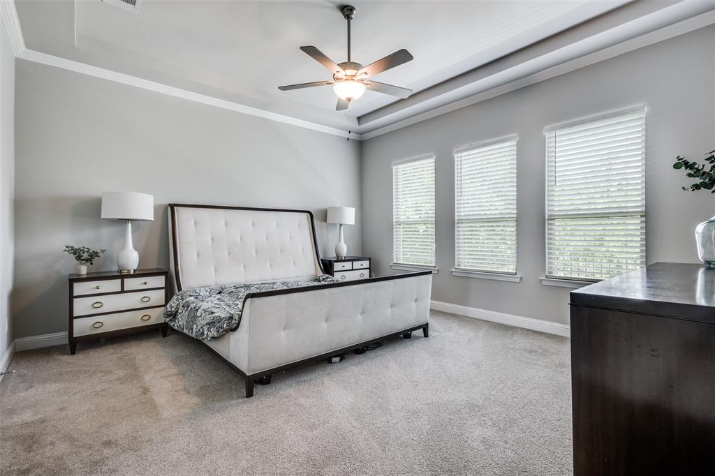 1113 Stone Bridge Pass Gunter, TX 75058 - Photo 14 of 32 a spacious bedroom with a bed and a large window