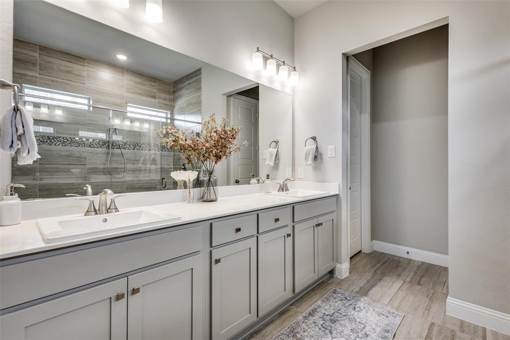 1113 Stone Bridge Pass Gunter, TX 75058 - Photo 15 of 32 a bathroom with double sink and a mirror
