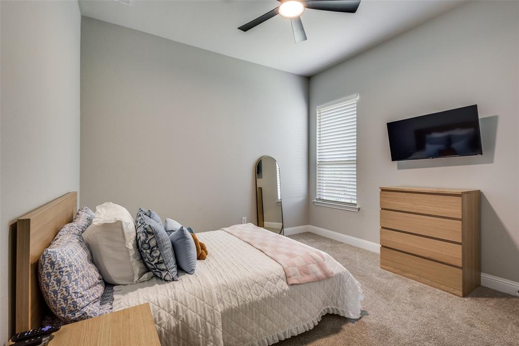 1113 Stone Bridge Pass Gunter, TX 75058 - Photo 19 of 32 a bedroom with a bed and a flat screen tv
