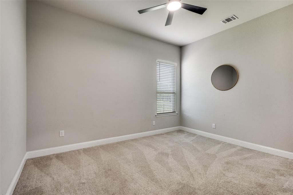 1113 Stone Bridge Pass Gunter, TX 75058 - Photo 20 of 32 an empty room with a window and a ceiling fan