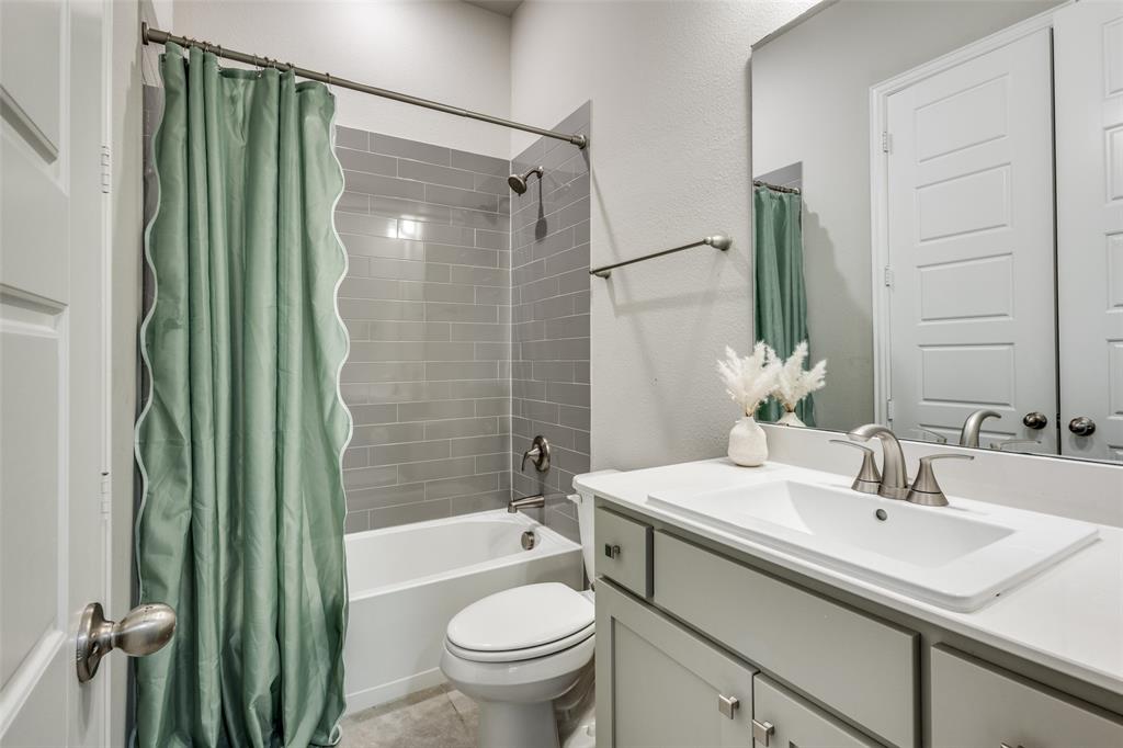 1113 Stone Bridge Pass Gunter, TX 75058 - Photo 21 of 32 a bathroom with a sink toilet and shower