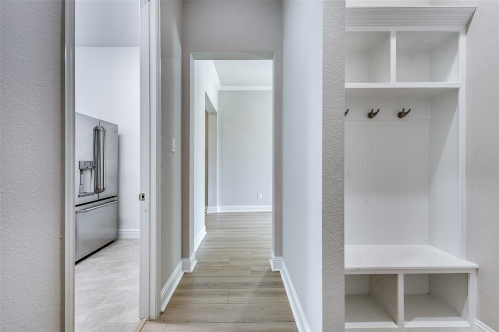 1113 Stone Bridge Pass Gunter, TX 75058 - Photo 24 of 32 a view of a hallway with wooden floor and staircase
