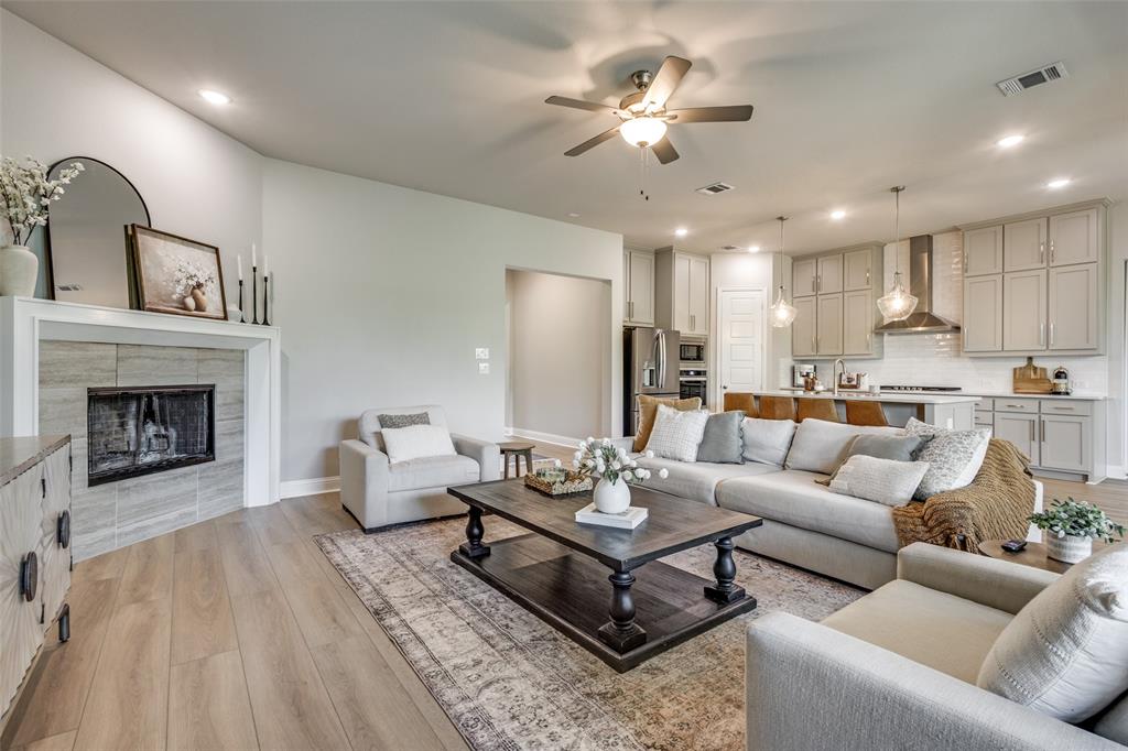 1113 Stone Bridge Pass Gunter, TX 75058 - Photo 4 of 32 a living room with furniture and a fireplace