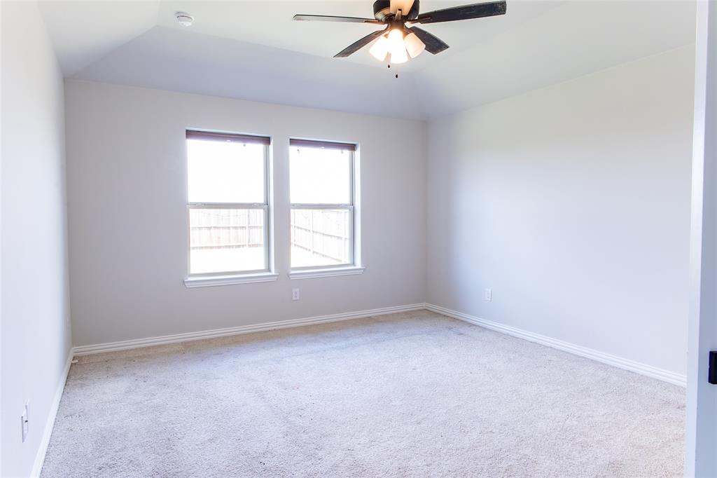 2604 Freeman Street Anna, TX 75409 - Photo 6 of 18 an empty room with a window and a fan