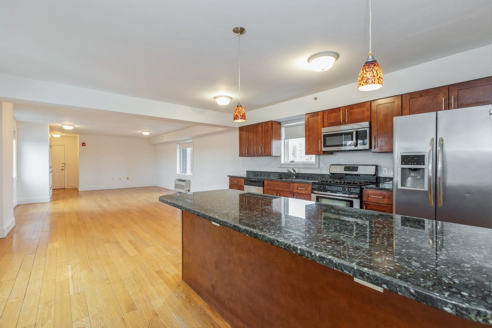 125 43rd Street, Unit 405 Union City, NJ 07087 - Photo 14 of 20 a kitchen with stainless steel appliances granite countertop a sink a stove counter space and cabinets