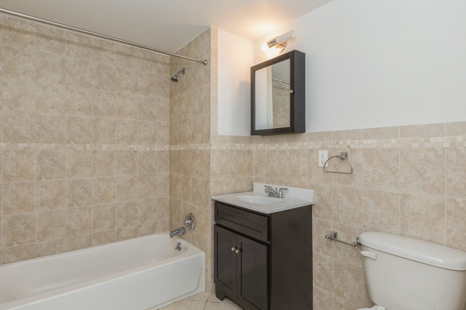 125 43rd Street, Unit 405 Union City, NJ 07087 - Photo 16 of 20 a bathroom with a sink toilet and shower