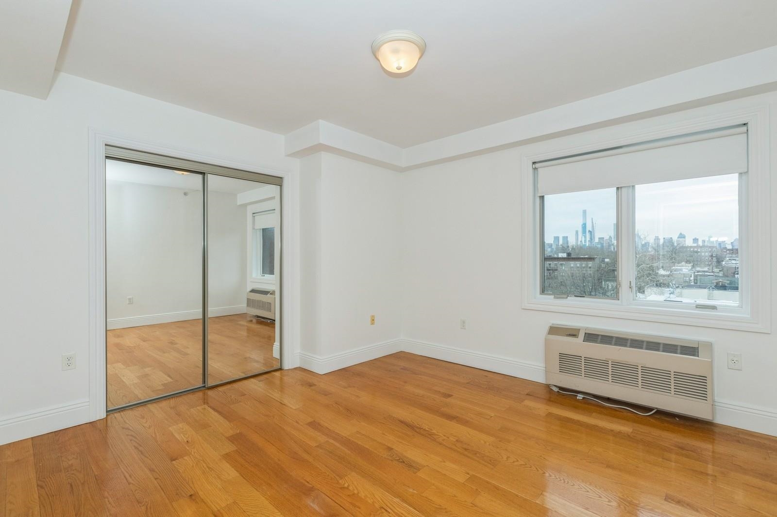 125 43rd Street, Unit 405 Union City, NJ 07087 - Photo 18 of 20 a view of an empty room with a window
