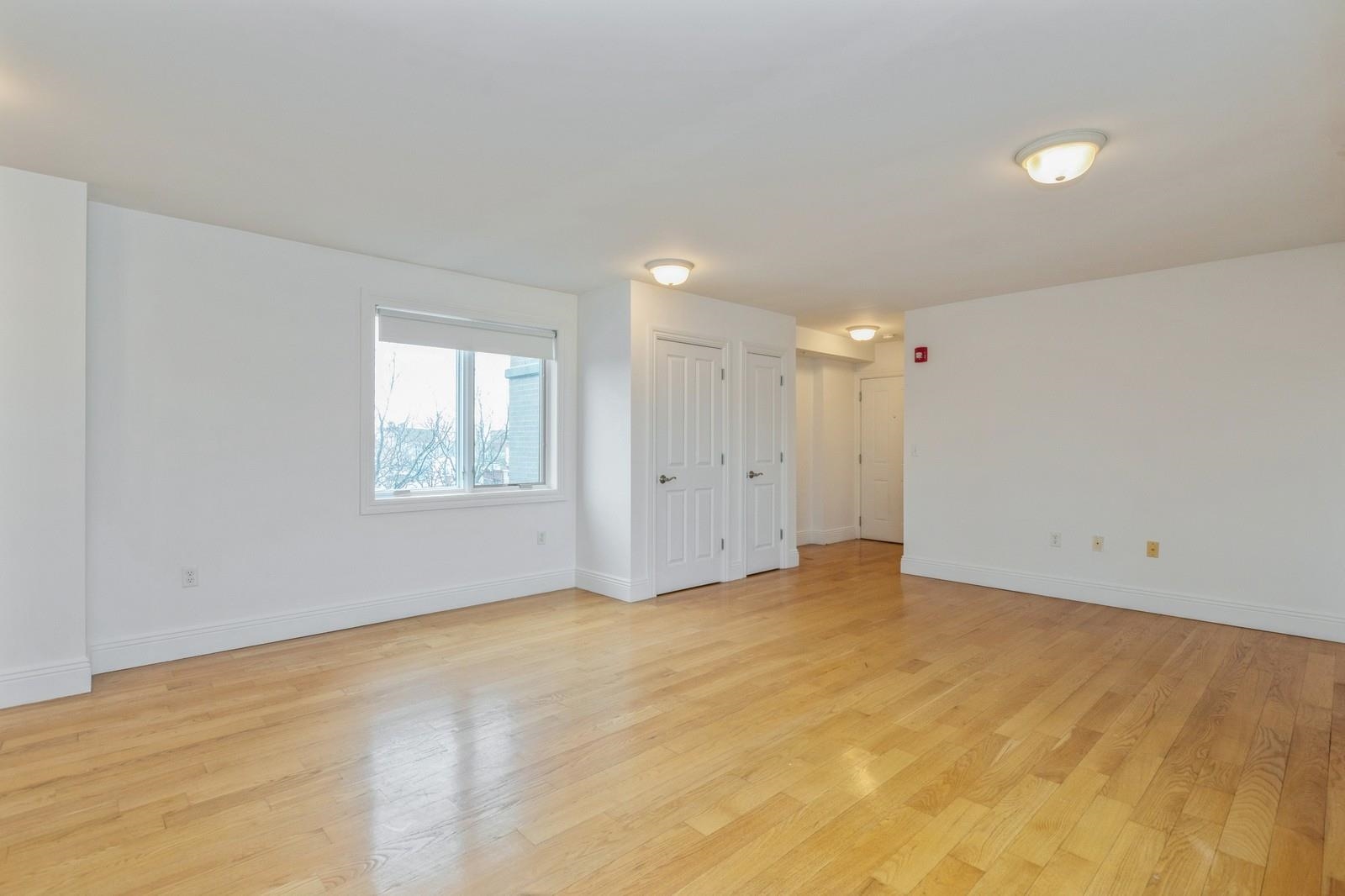 125 43rd Street, Unit 405 Union City, NJ 07087 - Photo 6 of 20 a view of an empty room with a window