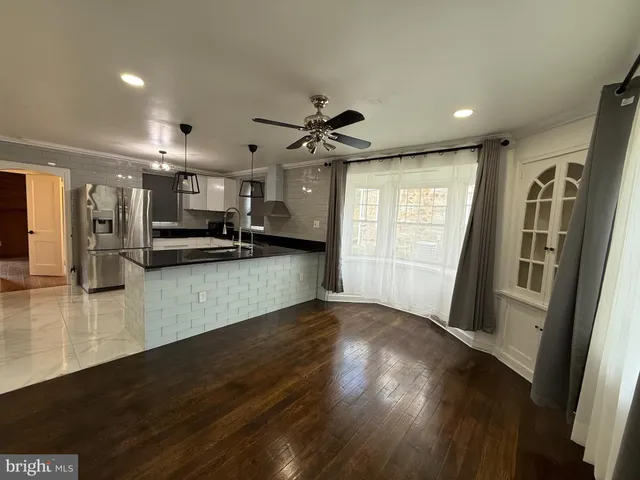 a view of a kitchen with a sink and a refrigerator