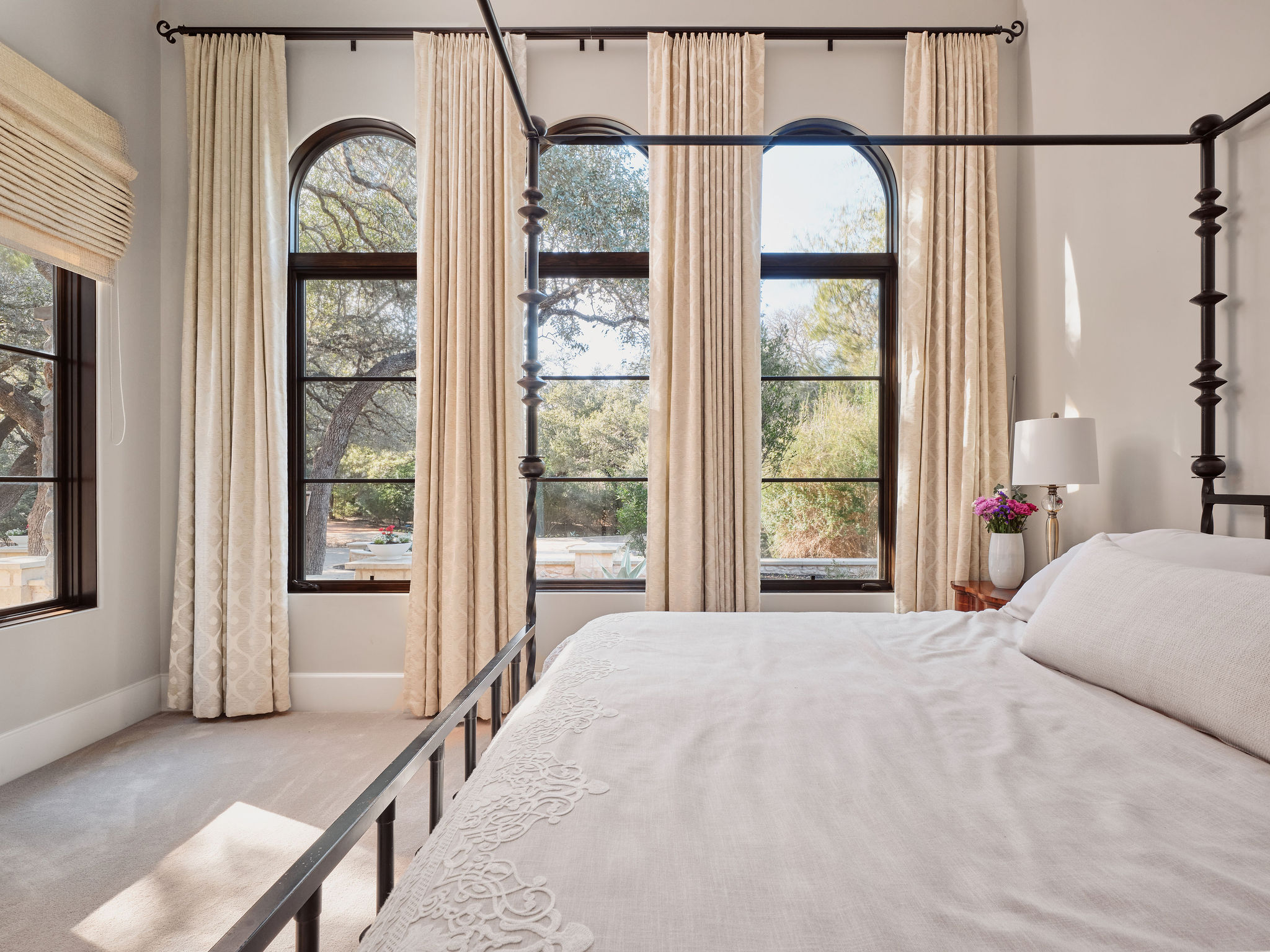 3667 Stoneridge Road Austin, TX 78746 - Photo 25 of 39 a bedroom with a bed and a large window