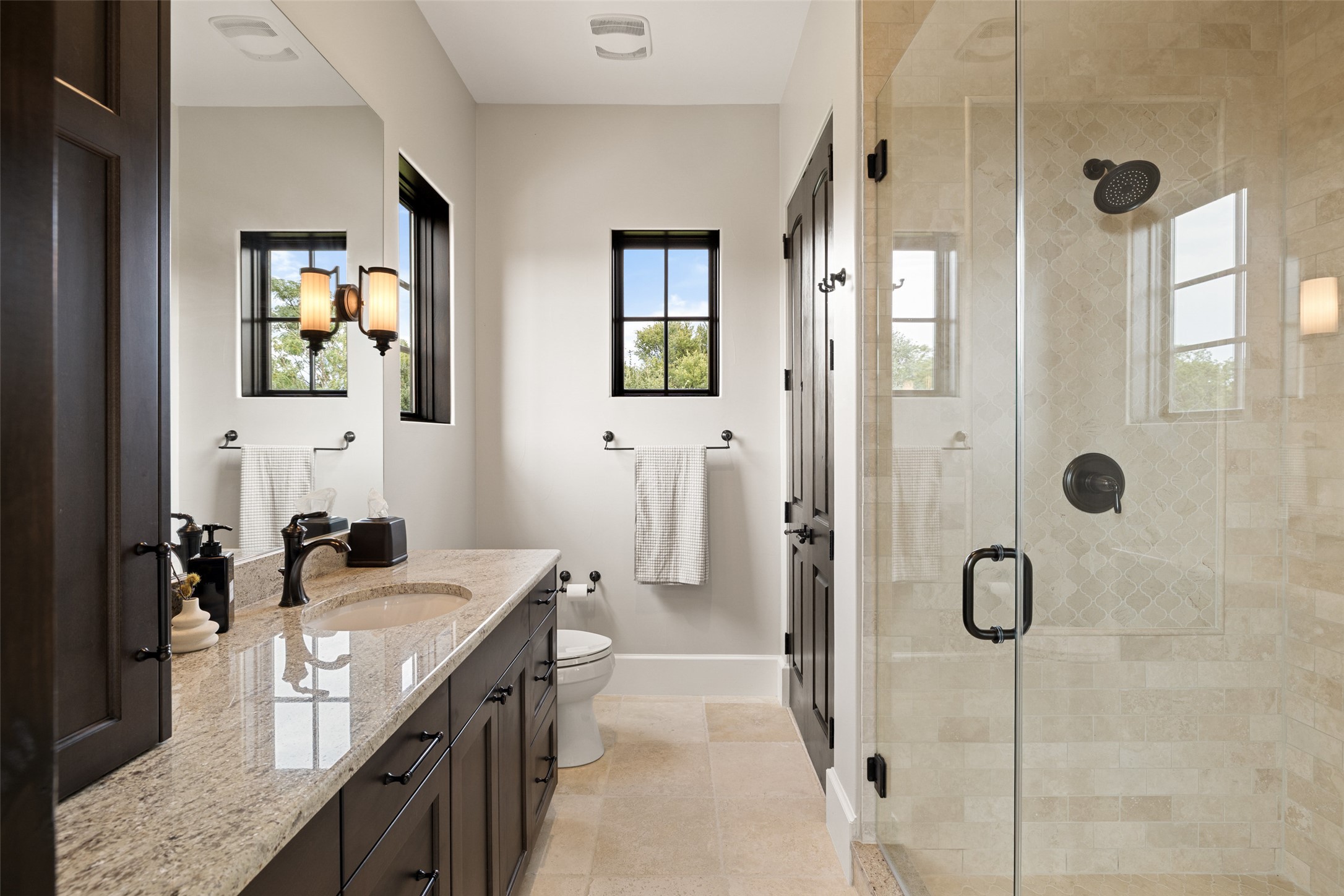 3667 Stoneridge Road Austin, TX 78746 - Photo 34 of 39 a bathroom with a granite countertop sink mirror and shower