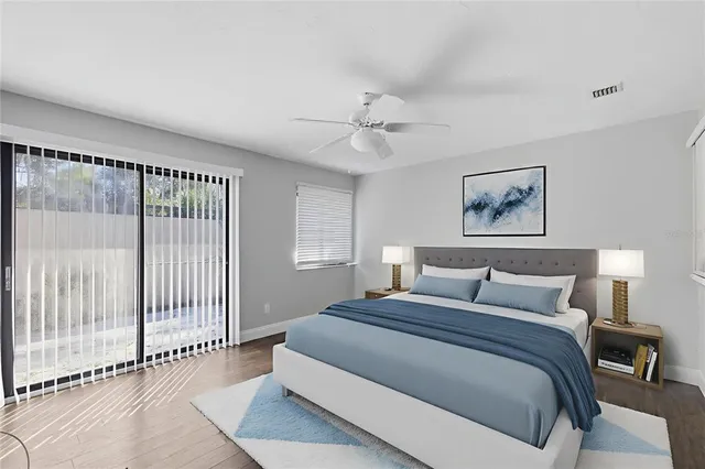 a bedroom with a large bed and a chandelier