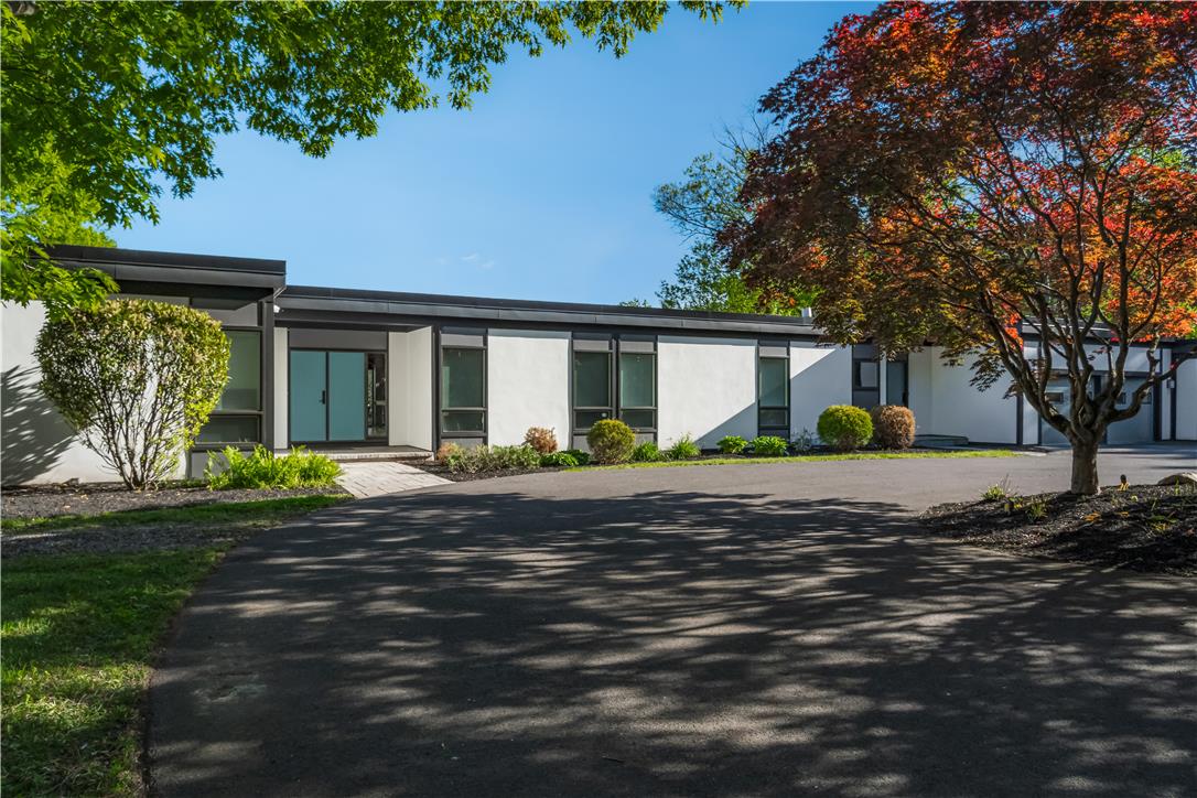 1506 Pleasant View Road Coopersburg, PA 18036 - Photo 1 of 97 A modern facade with striking blue double doors awaits, framed by lush landscaping and mature trees.