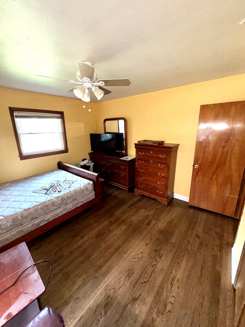 10741 Mason Avenue Chicago Ridge, IL 60415 - Photo 10 of 23 a bedroom with a bed and wooden floor