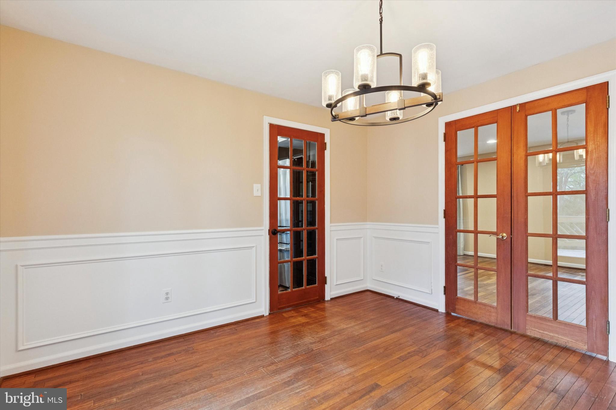 685 Hopewell Road Downingtown, PA 19335 - Photo 13 of 39 an empty room with wooden floor cabinet and windows