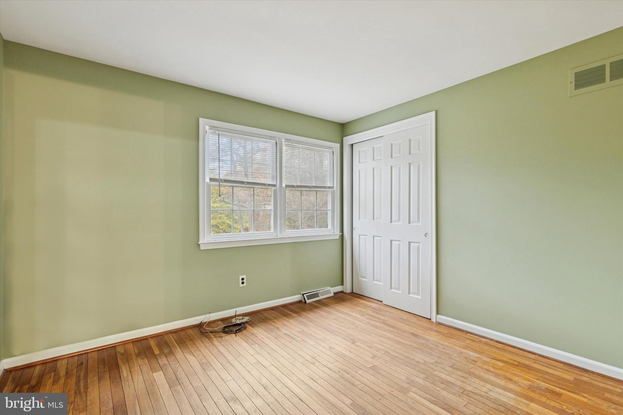 685 Hopewell Road Downingtown, PA 19335 - Photo 20 of 39 an empty room with wooden floor and windows