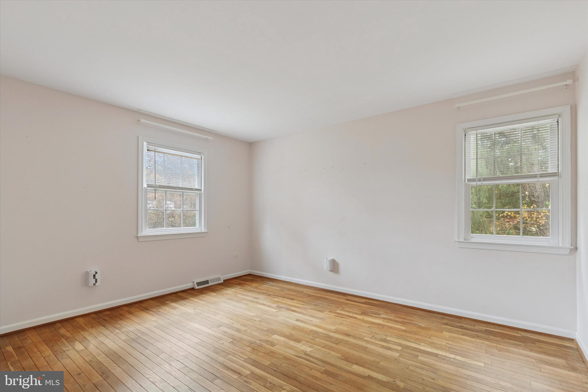 685 Hopewell Road Downingtown, PA 19335 - Photo 22 of 39 a view of an empty room with wooden floor and a window