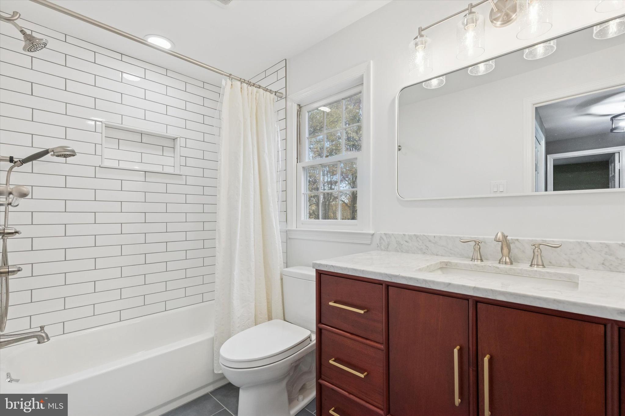 685 Hopewell Road Downingtown, PA 19335 - Photo 26 of 39 a bathroom with a sink toilet a mirror and shower