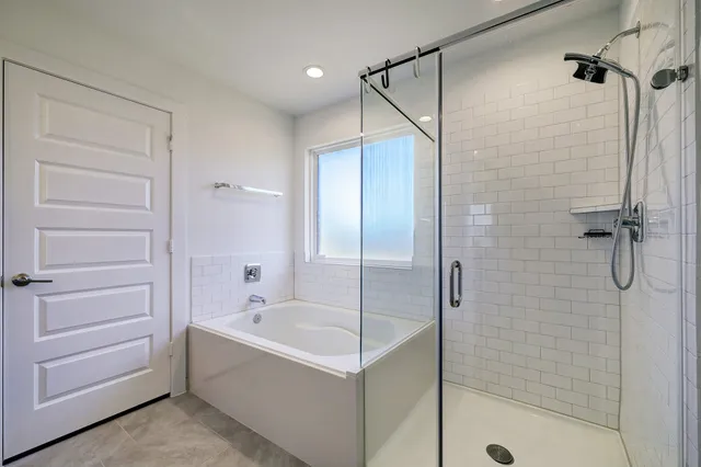 a bathroom with a bathtub and a shower