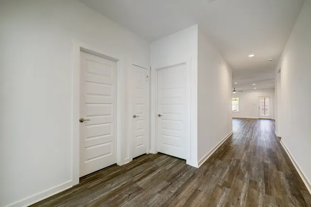 a view of a hallway with wooden floor