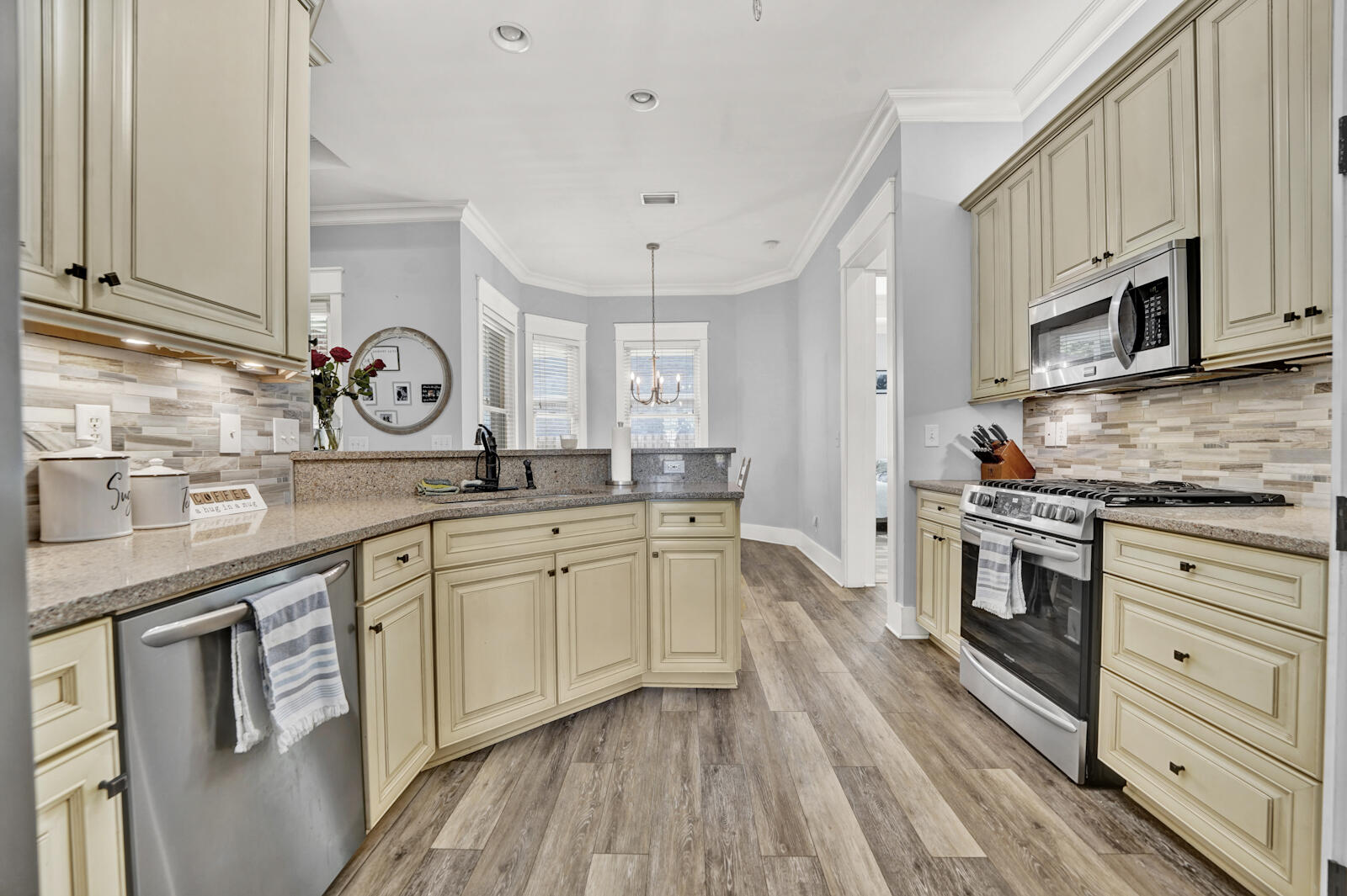 738 Symphony Way Freeport, FL 32439 - Photo 13 of 69 a large kitchen with stainless steel appliances granite countertop a stove and a sink