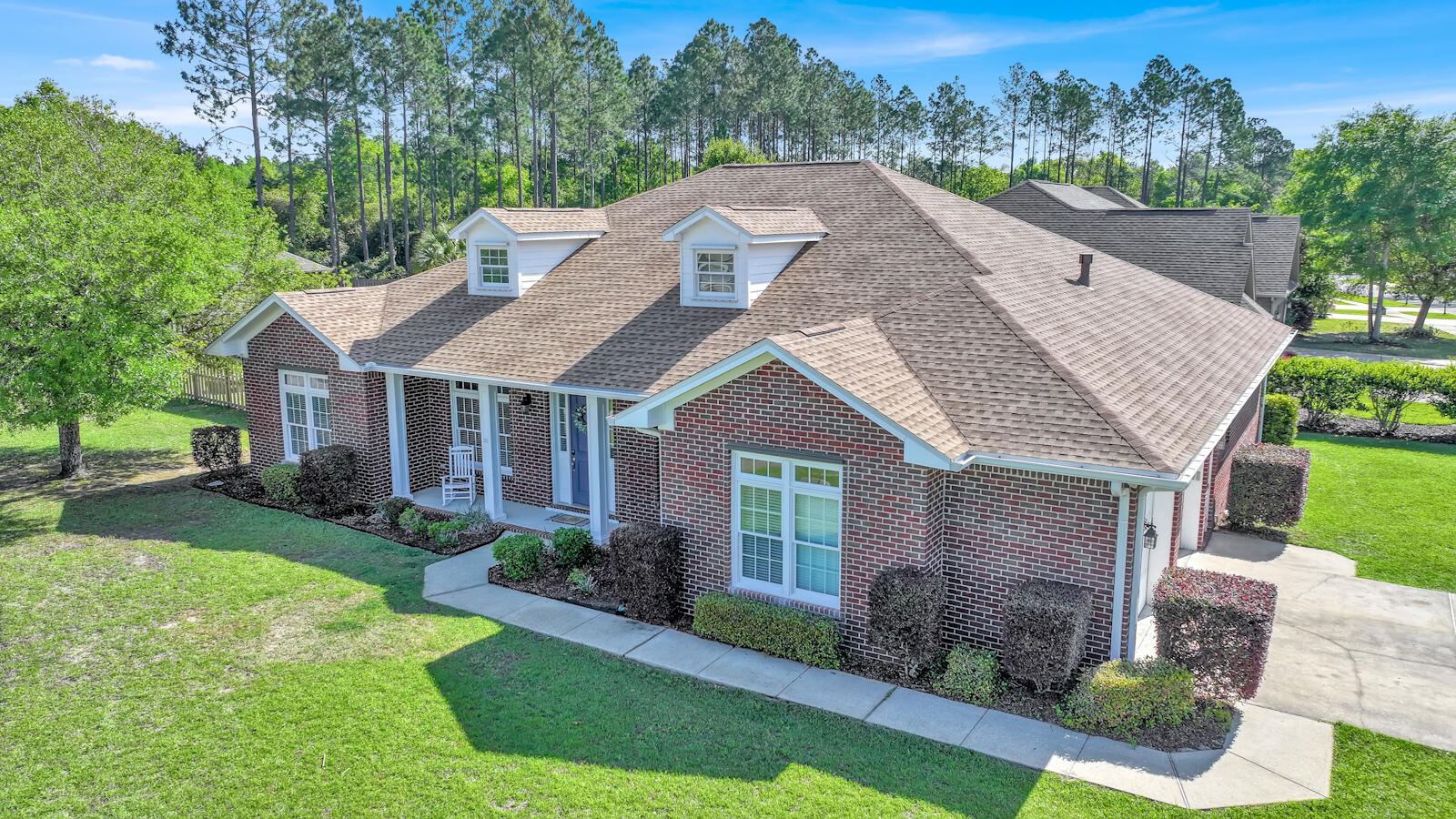 738 Symphony Way Freeport, FL 32439 - Photo 2 of 69 a aerial view of a house next to a big yard and large trees
